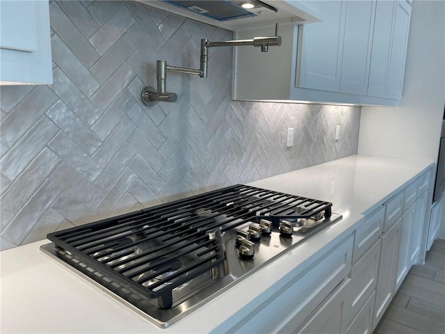 13941 Flintlock Dr, Corpus Christi, TX 78418 - kitchen view of pot filler, stainless steel gas stovetop, backsplash, and light countertops