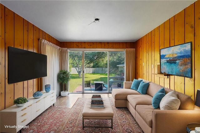 living room featuring hardwood / wood-style flooring and wooden walls