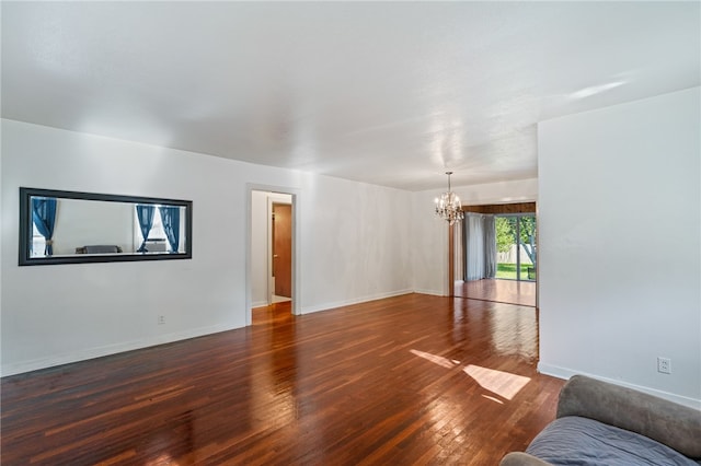 living room with dark hardwood / wood-style flooring and a chandelier