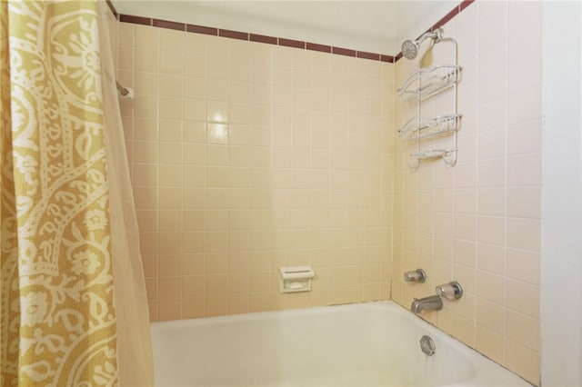 bathroom with shower / bath combination with curtain