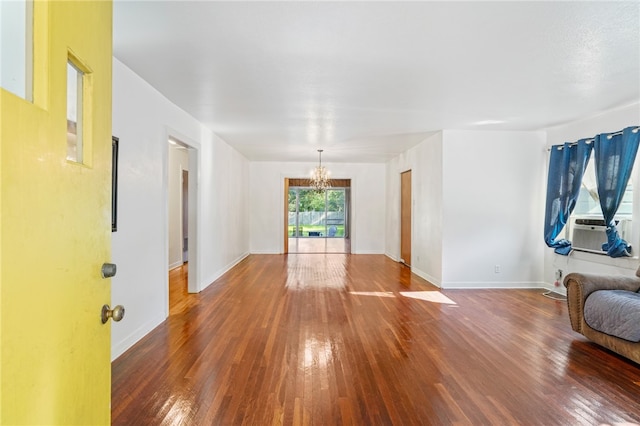 living room featuring hardwood / wood-style flooring, cooling unit, and a chandelier