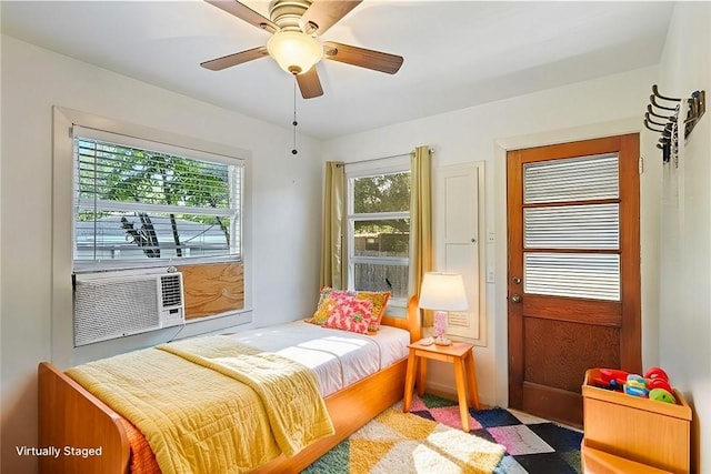 bedroom featuring ceiling fan and cooling unit