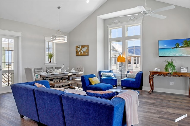 living room featuring dark wood-type flooring, high vaulted ceiling, and a healthy amount of sunlight