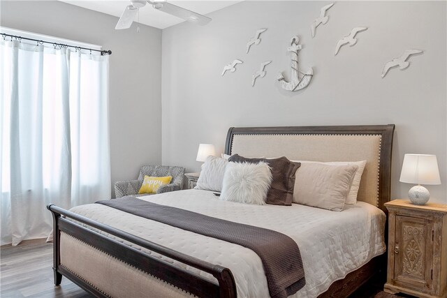 bedroom with ceiling fan and light hardwood / wood-style flooring