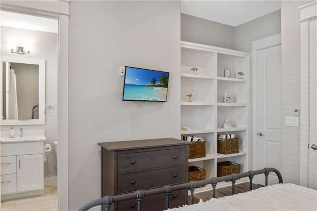 bedroom featuring sink and light hardwood / wood-style flooring