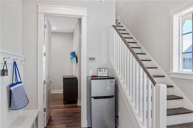 staircase with hardwood / wood-style floors