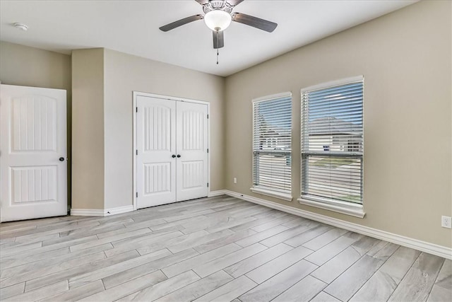 unfurnished bedroom featuring a closet, ceiling fan, and light hardwood / wood-style flooring