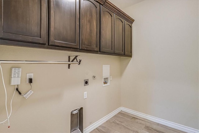 laundry area featuring cabinets, hookup for a gas dryer, washer hookup, electric dryer hookup, and light wood-type flooring