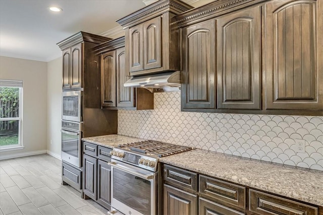 kitchen featuring stainless steel range, dark brown cabinetry, decorative backsplash, and ornamental molding