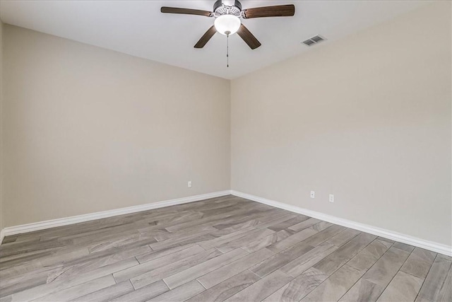 spare room with ceiling fan and light wood-type flooring