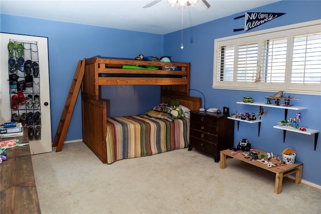 carpeted bedroom featuring ceiling fan and baseboards