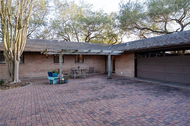 view of front of home featuring brick siding and an attached garage