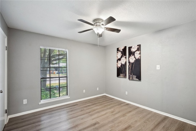 empty room with hardwood / wood-style floors and ceiling fan