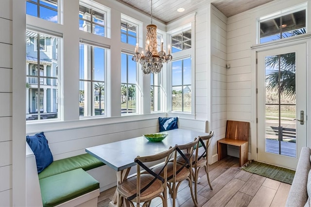 sunroom featuring wooden ceiling and a healthy amount of sunlight