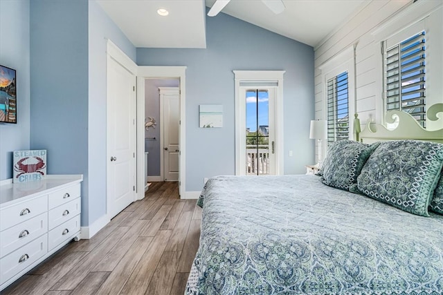 bedroom with lofted ceiling, access to outside, wood finished floors, and baseboards