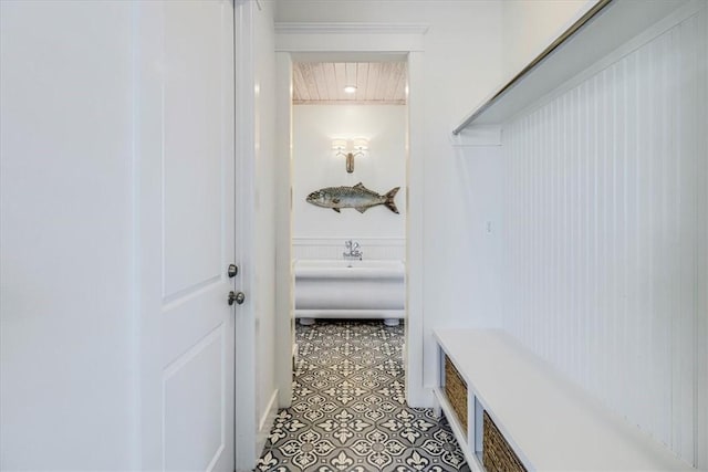 mudroom featuring a wainscoted wall and light tile patterned floors