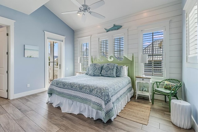 bedroom with lofted ceiling, ceiling fan, wood finished floors, access to outside, and baseboards