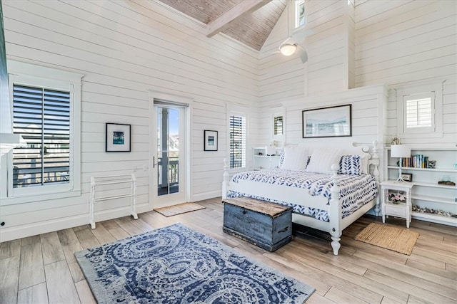 bedroom with wood ceiling, multiple windows, high vaulted ceiling, and wood finished floors