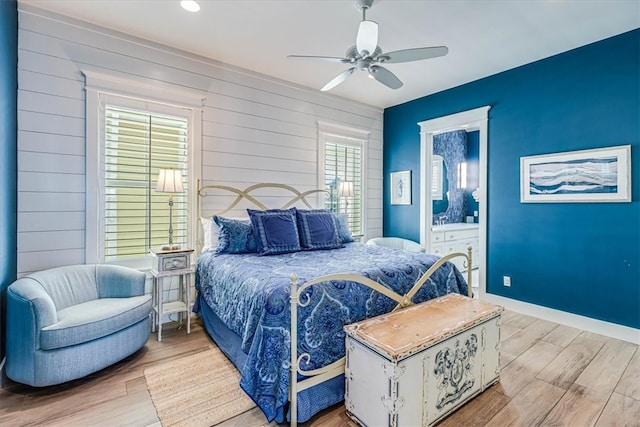 bedroom with light wood-style floors, baseboards, and a ceiling fan