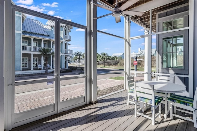 unfurnished sunroom with a ceiling fan