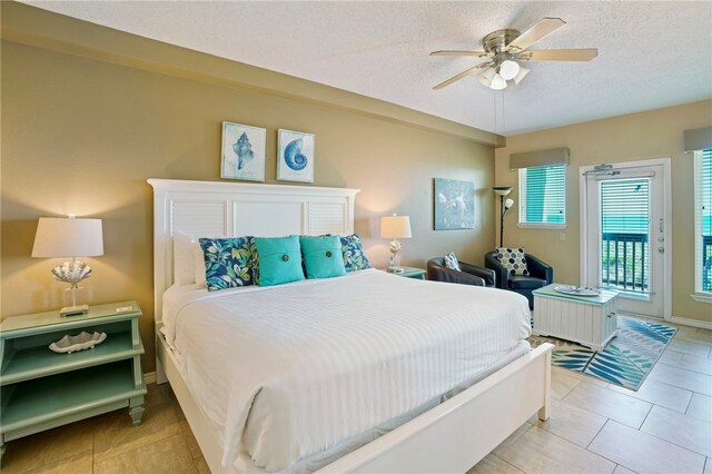 bedroom featuring ceiling fan, access to exterior, a textured ceiling, and light tile patterned floors