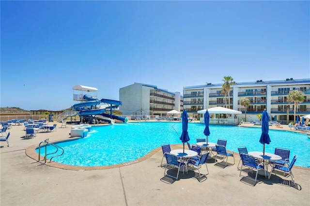 view of pool with a patio and a water slide