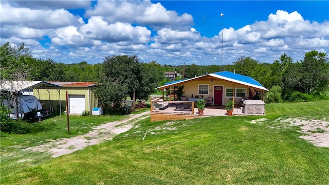 view of yard featuring an outbuilding, a garage, and a wooden deck