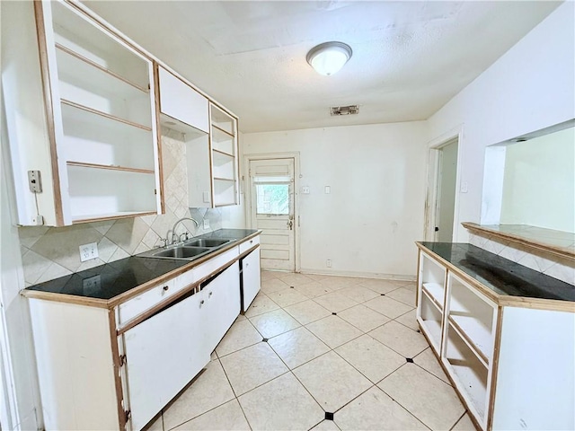 kitchen featuring open shelves, white cabinets, a sink, and tasteful backsplash