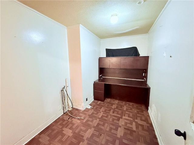 unfurnished bedroom featuring crown molding, a textured ceiling, baseboards, and parquet floors