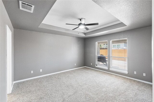 13948 Lighthouse Dr, Corpus Christi, TX 78418 - carpeted spare room with a tray ceiling, ceiling fan, baseboards, and a textured ceiling