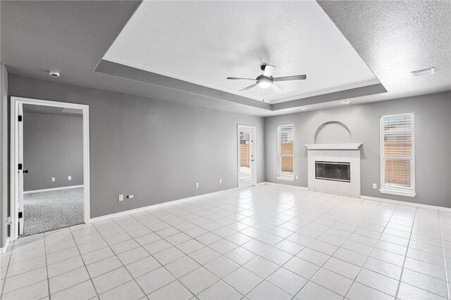 13948 Lighthouse Dr, Corpus Christi, TX 78418 - unfurnished living room featuring a raised ceiling, ceiling fan, a textured ceiling, a fireplace, and baseboards