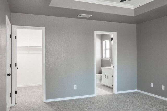 13948 Lighthouse Dr, Corpus Christi, TX 78418 - unfurnished bedroom with a spacious closet, carpet, crown molding, a closet, and baseboards