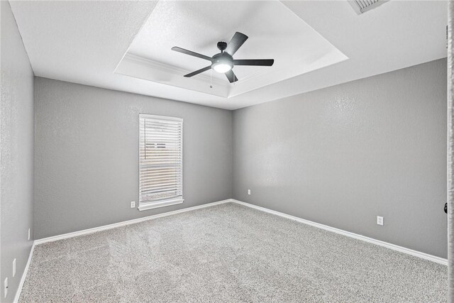 13948 Lighthouse Dr, Corpus Christi, TX 78418 - carpeted spare room featuring a raised ceiling, ceiling fan, and baseboards