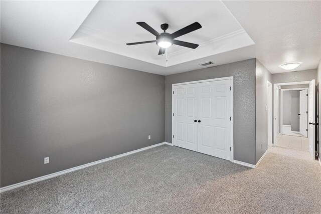 13948 Lighthouse Dr, Corpus Christi, TX 78418 - unfurnished bedroom with a raised ceiling, carpet, a closet, baseboards, and a textured wall