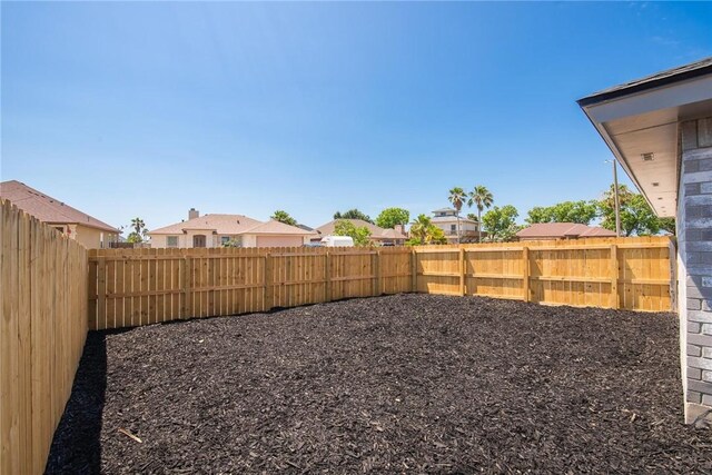 13948 Lighthouse Dr, Corpus Christi, TX 78418 - fenced backyard featuring a residential view
