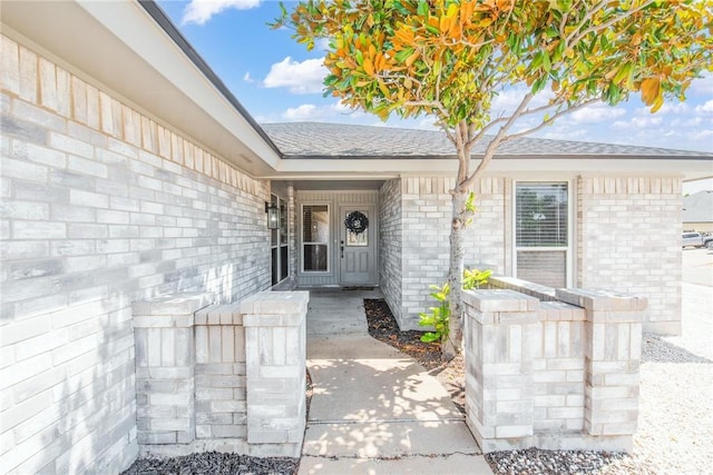 13948 Lighthouse Dr, Corpus Christi, TX 78418 - entrance to property featuring a shingled roof and brick siding