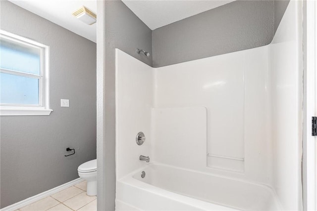 13948 Lighthouse Dr, Corpus Christi, TX 78418 - bathroom featuring toilet, tile patterned floors, washtub / shower combination, and baseboards
