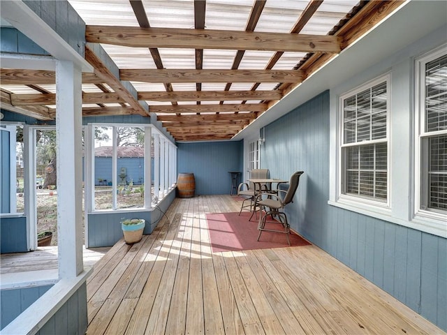 unfurnished sunroom with beamed ceiling