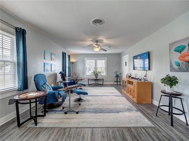 sitting room with ceiling fan and hardwood / wood-style floors