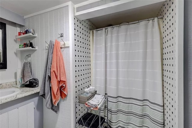 bathroom featuring vanity and curtained shower