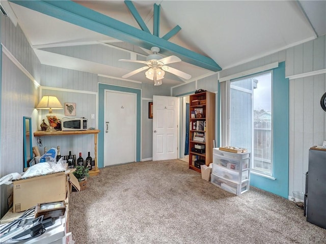 sitting room with ceiling fan, vaulted ceiling, and carpet