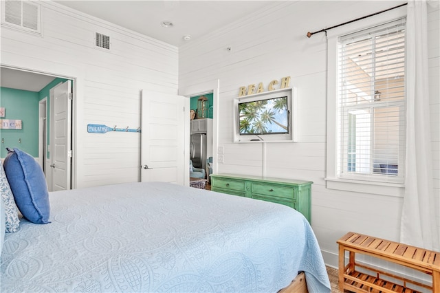 bedroom featuring hardwood / wood-style floors and crown molding