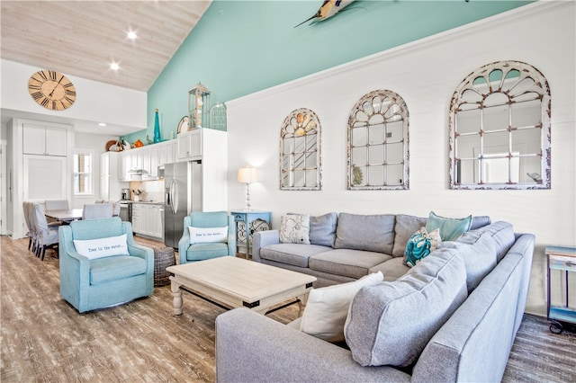 living room with high vaulted ceiling and wood-type flooring