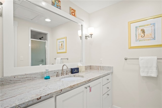 bathroom with an enclosed shower and vanity