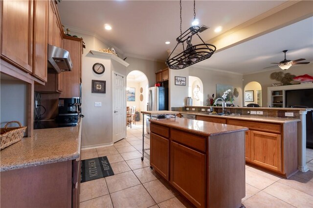 7602 Beau Terre, Corpus Christi, TX 78414 - kitchen with arched walkways, extractor fan, a kitchen island, ornamental molding, and a ceiling fan
