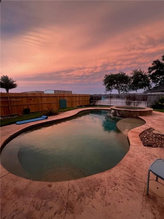 7602 Beau Terre, Corpus Christi, TX 78414 - pool at dusk featuring a pool with connected hot tub, a fenced backyard, and a patio area