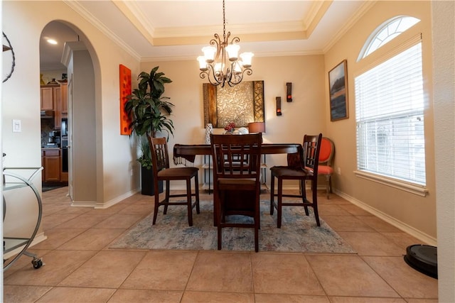 7602 Beau Terre, Corpus Christi, TX 78414 - dining area featuring arched walkways, a chandelier, ornamental molding, light tile patterned floors, and a raised ceiling