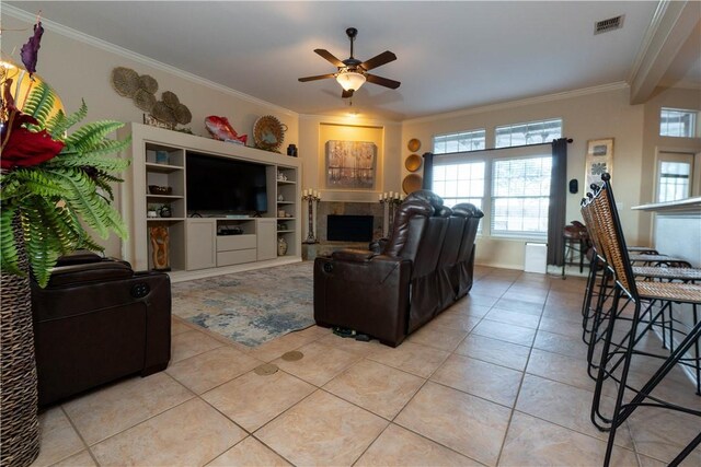 7602 Beau Terre, Corpus Christi, TX 78414 - living room featuring crown molding, a ceiling fan, light tile patterned floors, and a tile fireplace