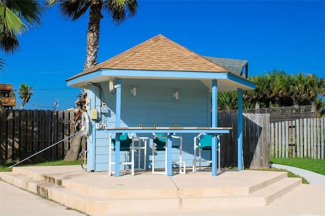 exterior space featuring a gazebo, exterior bar, and a patio area