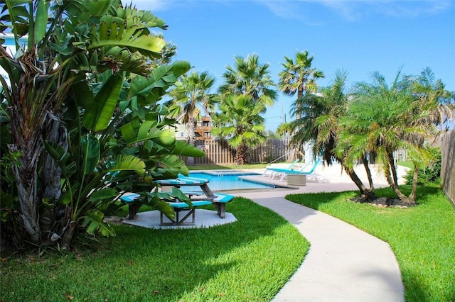 view of community with a yard and a pool